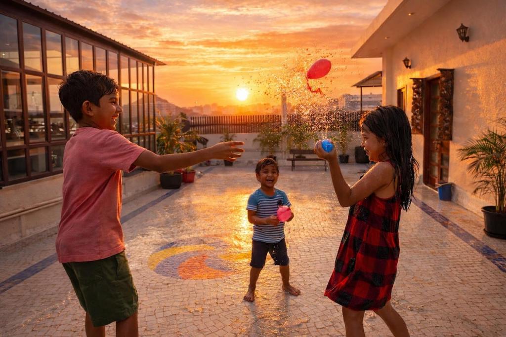 two children playing with a ball on a patio at Ghare Stays Udaipur in Udaipur