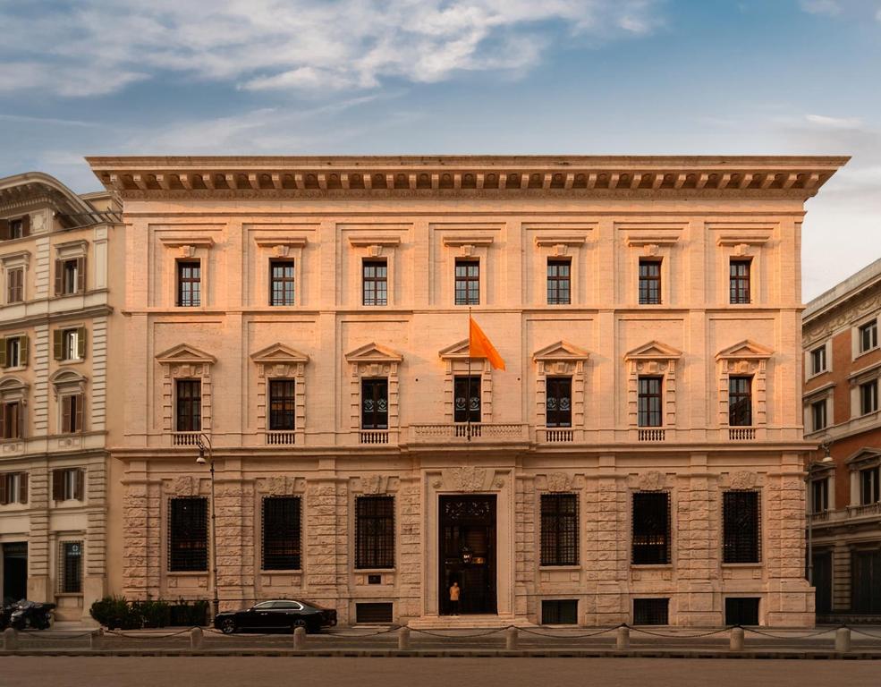 a large brick building with an orange flag on it at Corinthia Rome in Rome