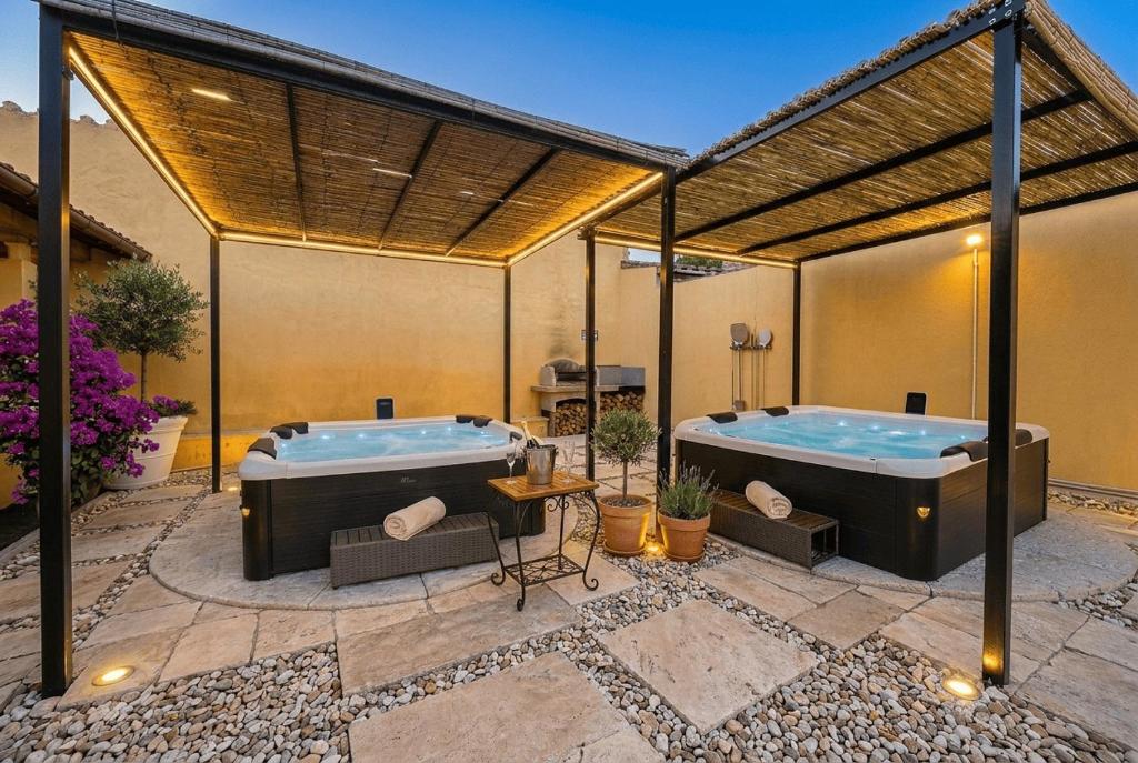 two hot tubs on a patio with at Costa Ovest Apartment Waves in Nurachi