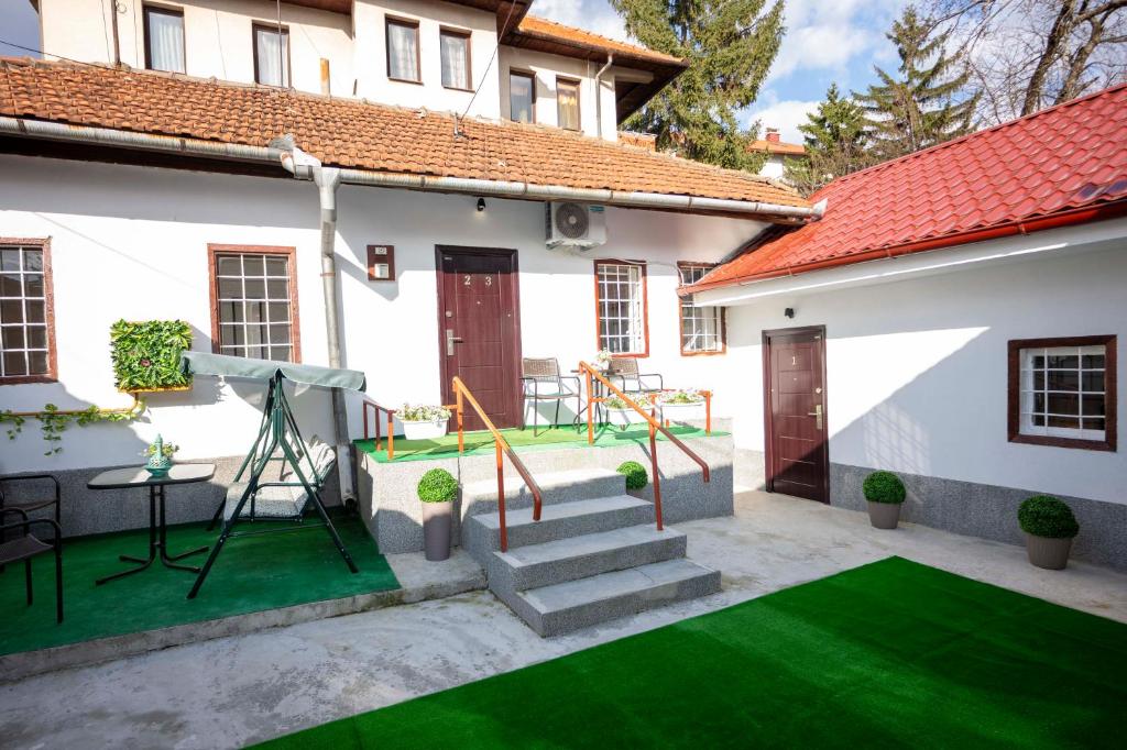 a yard with a playground in a house at Bosanska Avlija Authentic Sarajevo Stay with Garden in Sarajevo