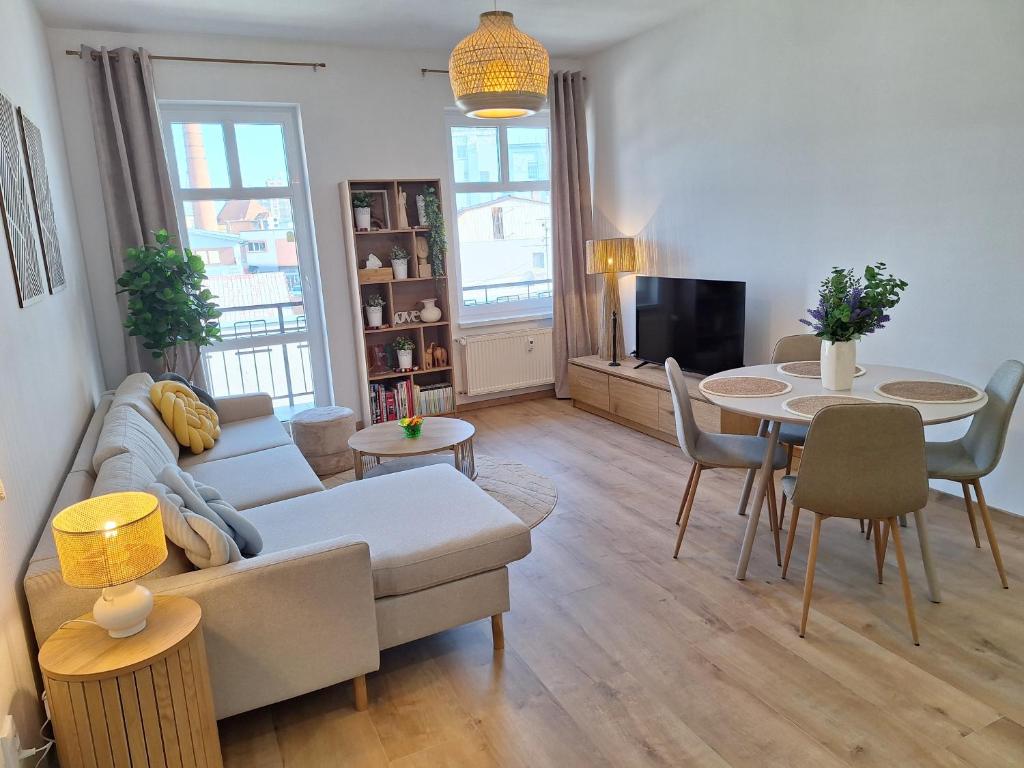 a living room with a couch and a table at Apartmán Stará Tržnica in Trenčín