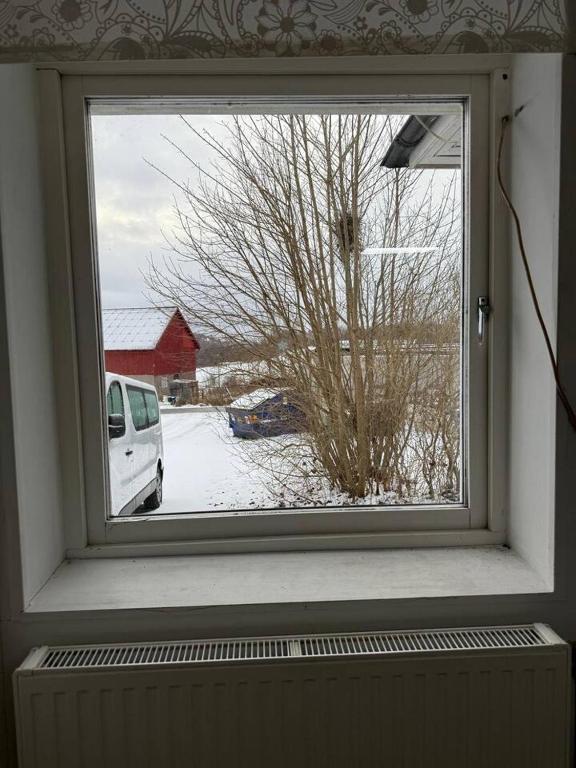 a window with a view of a snow covered yard at Workers Stay - Staff Accommodation Säve - Göteborg in Säve