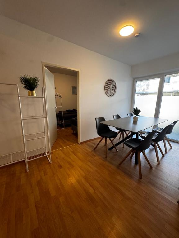 a dining room with a table and chairs at Linz Wasserwald - cozy 2BR Apartment in Linz