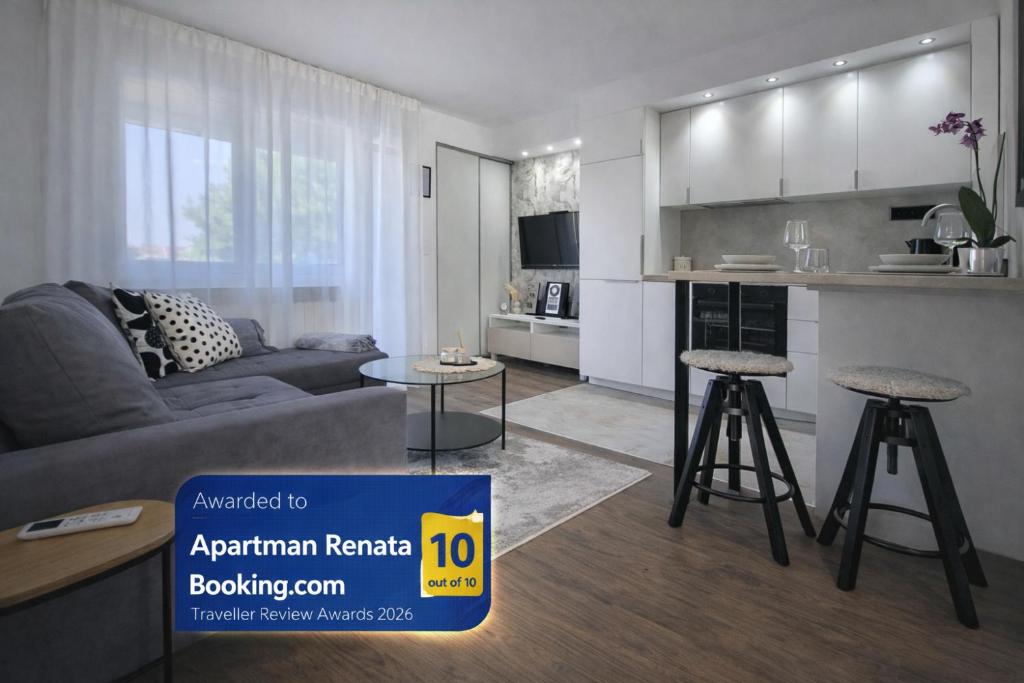 a living room with a couch and a kitchen at Apartman Renata in Županja
