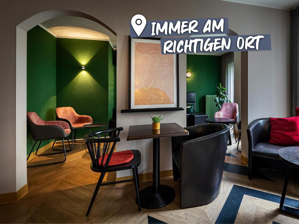 a bar with chairs and a table in a room at ACHAT Hotel Dresden Elbufer in Dresden