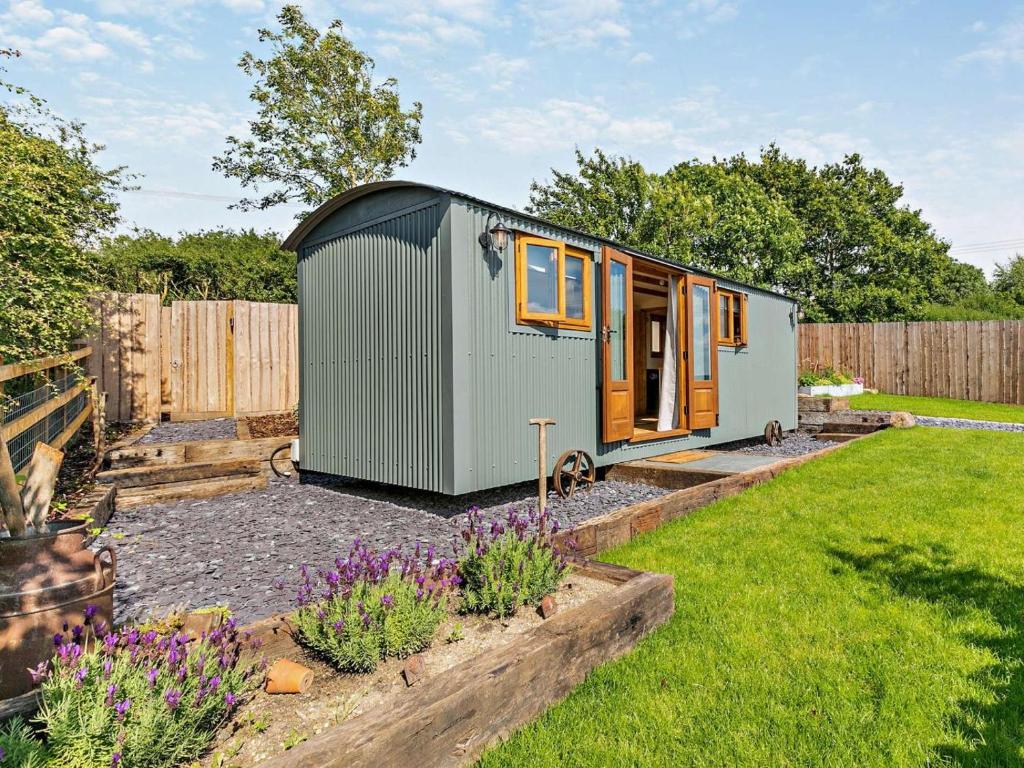 a tiny house sitting in a yard at 1 Bed in Cheltenham oc-95422 in Cheltenham