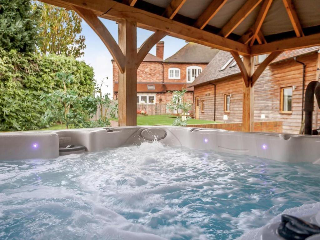 a jacuzzi tub in the backyard of a house at 3 Bed in Worcester oc-41983 in Broadwas