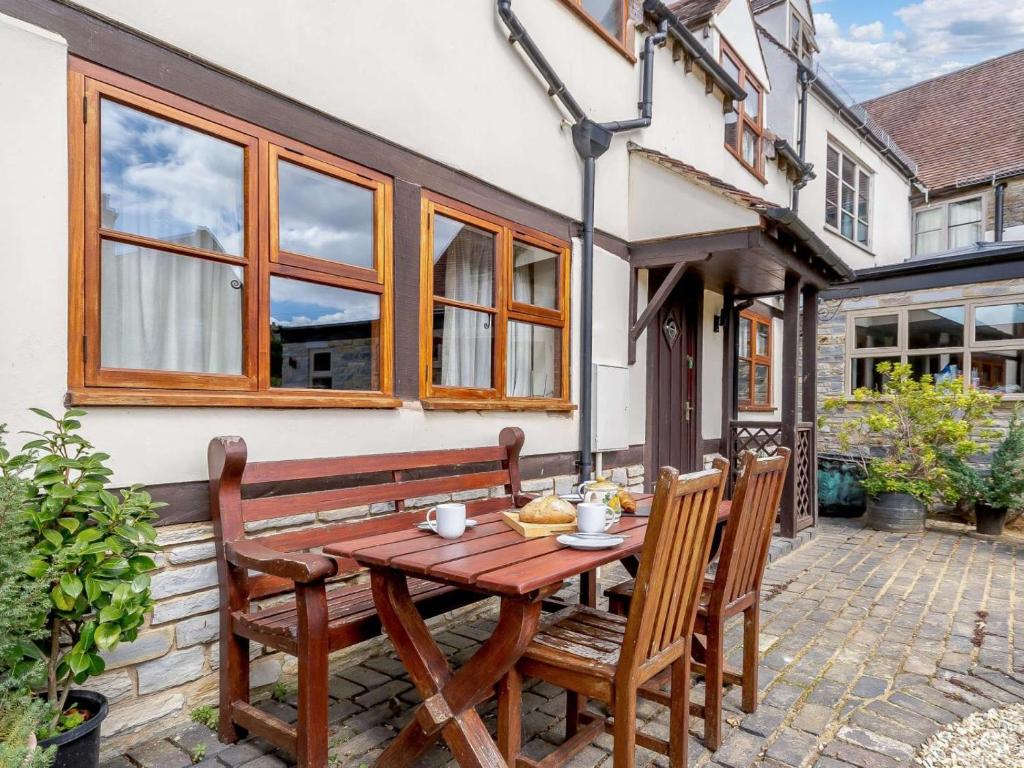 a wooden table and chairs on a patio at 2 Bed in Evesham oc-89476 in Bretforton