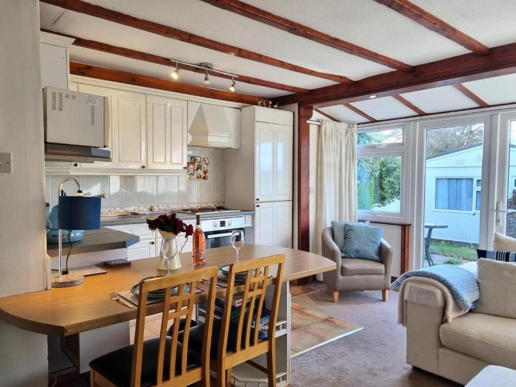 a kitchen and dining room with a table and chairs at 2 Bed in Galmpton oc-bx008 in Galmpton-on-the-Dart