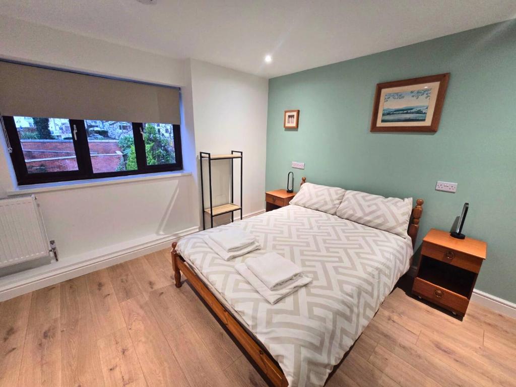 a bedroom with a bed and a window at The Elements Residence in Chepstow