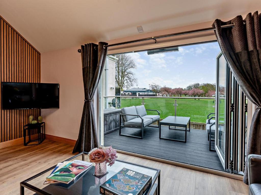 a living room with a large sliding glass door at 2 Bed in Castle Douglas oc-59637 in Castle Douglas