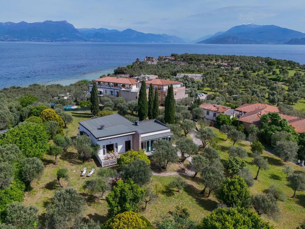 an aerial view of a house on an island in the water at MGH - Villa Sirmione in Sirmione