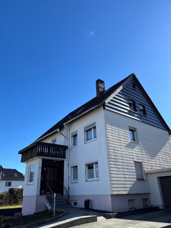 a white building with a black roof at fewo-twete in Stadtoldendorf