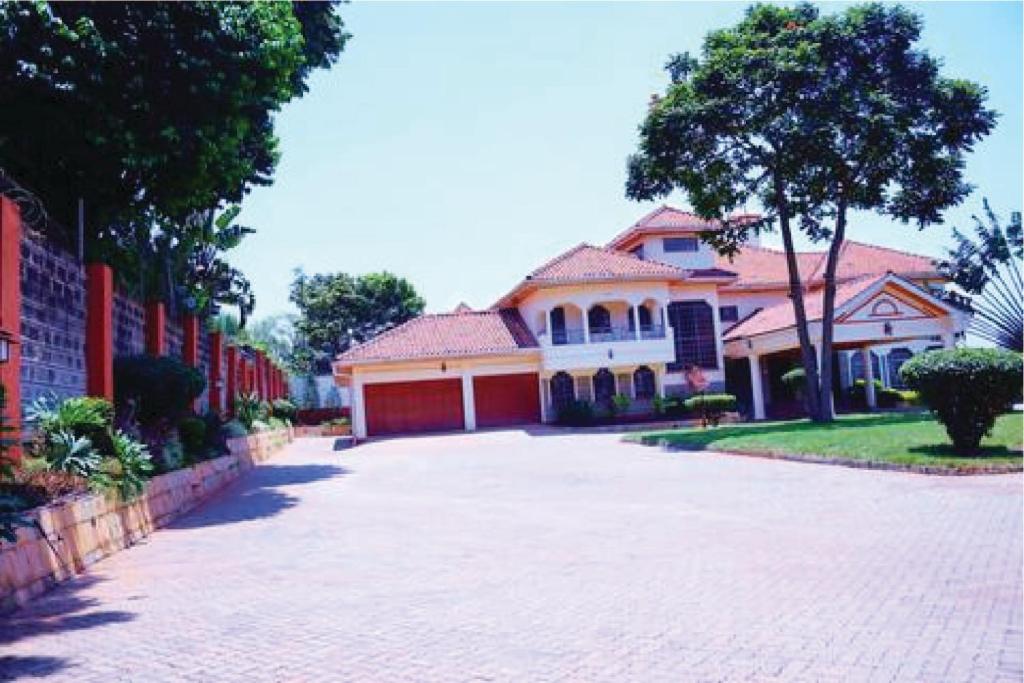 a brick driveway in front of a house at Orchard Manor in Nairobi