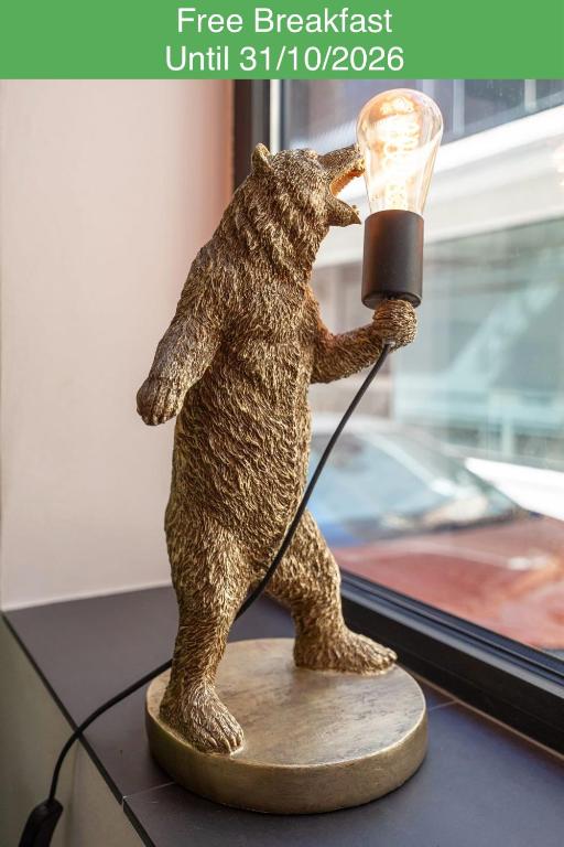 a statue of a bear holding a lamp at The Bear and Ween in St. Julianʼs