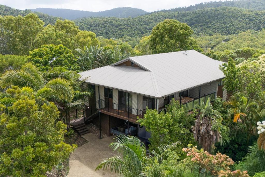 an aerial view of a house in the forest at Curlew Cove in Airlie Beach