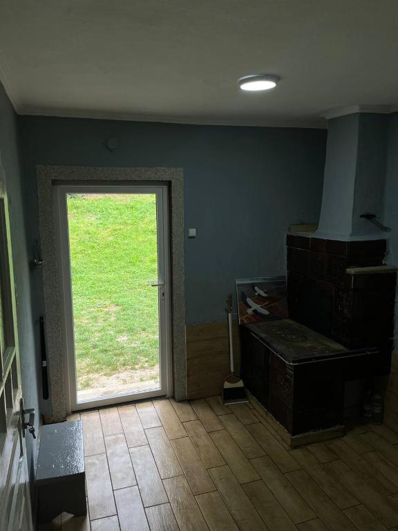 a room with a door with a window in it at Дідова Хата in Sheshory
