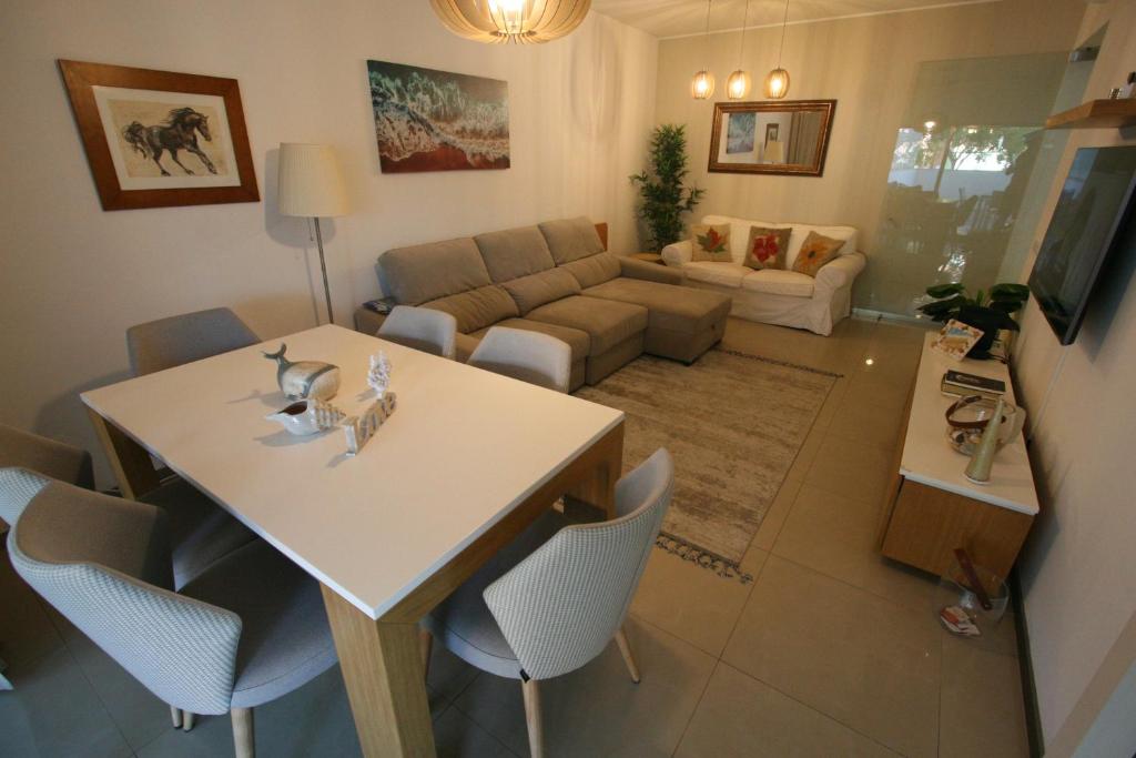 a living room with a table and a couch at Foz Palace - Praia da Rocha in Portimão