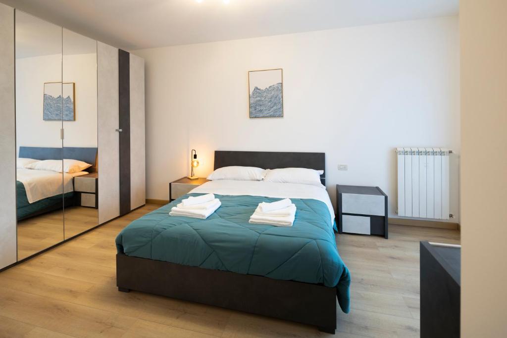 a bedroom with a large bed and a mirror at - Magenta Apartment - in Monfalcone
