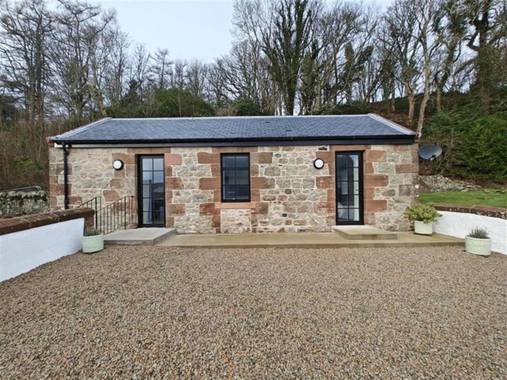 a small stone house with a slate roof at 1 Bed in Isle Of Arran oc-96463 in Dougarie