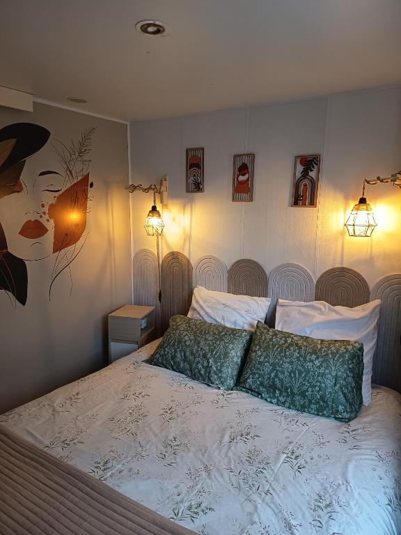 a bedroom with a bed with two pillows on it at Mobile home in Quimper
