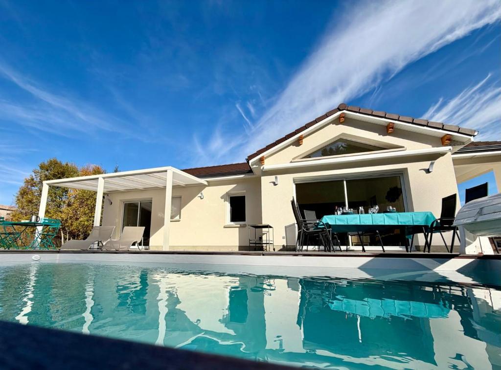 a house with a swimming pool in front of a house at Ma Bonne Etoile in Anould