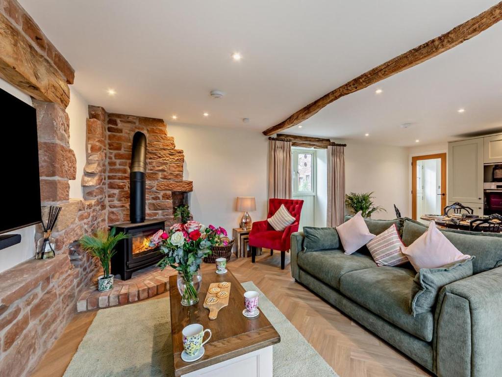 a living room with a couch and a fireplace at 2 Bed in Carlisle oc-96302 in Scaleby