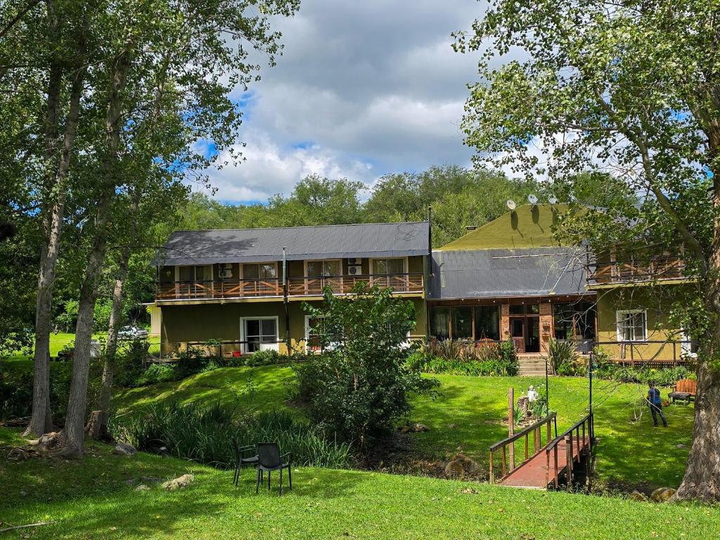 a large house on a hill with a yard at Posada Quellen in Villa General Belgrano