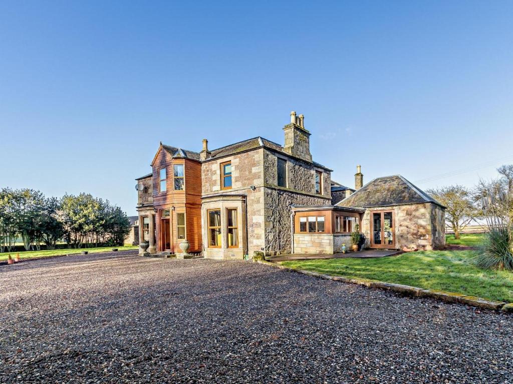 an old stone house on a gravel driveway at 7 Bed in Cupar oc-81242 in Cupar