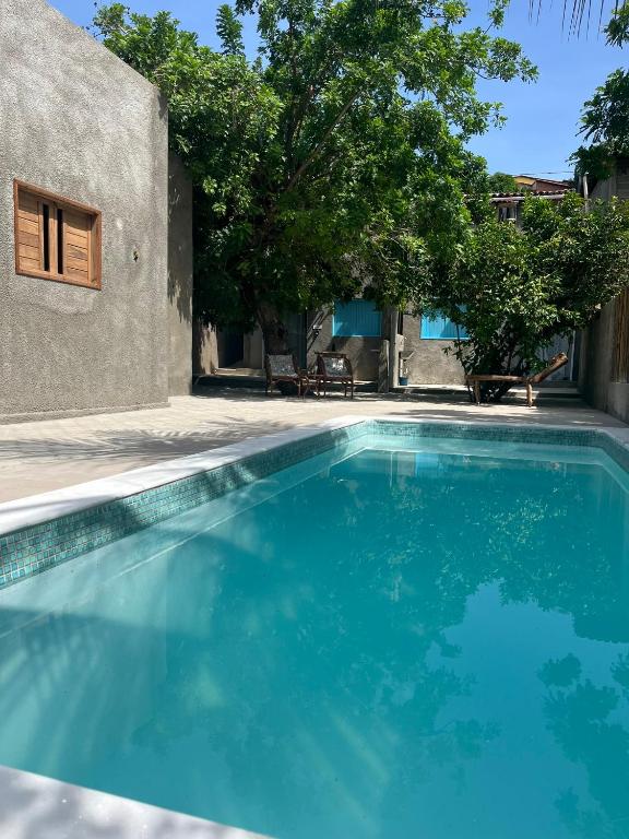 a swimming pool in front of a house at CASINHA JASMIM, vila florescer, centro histórico!! in Piranhas