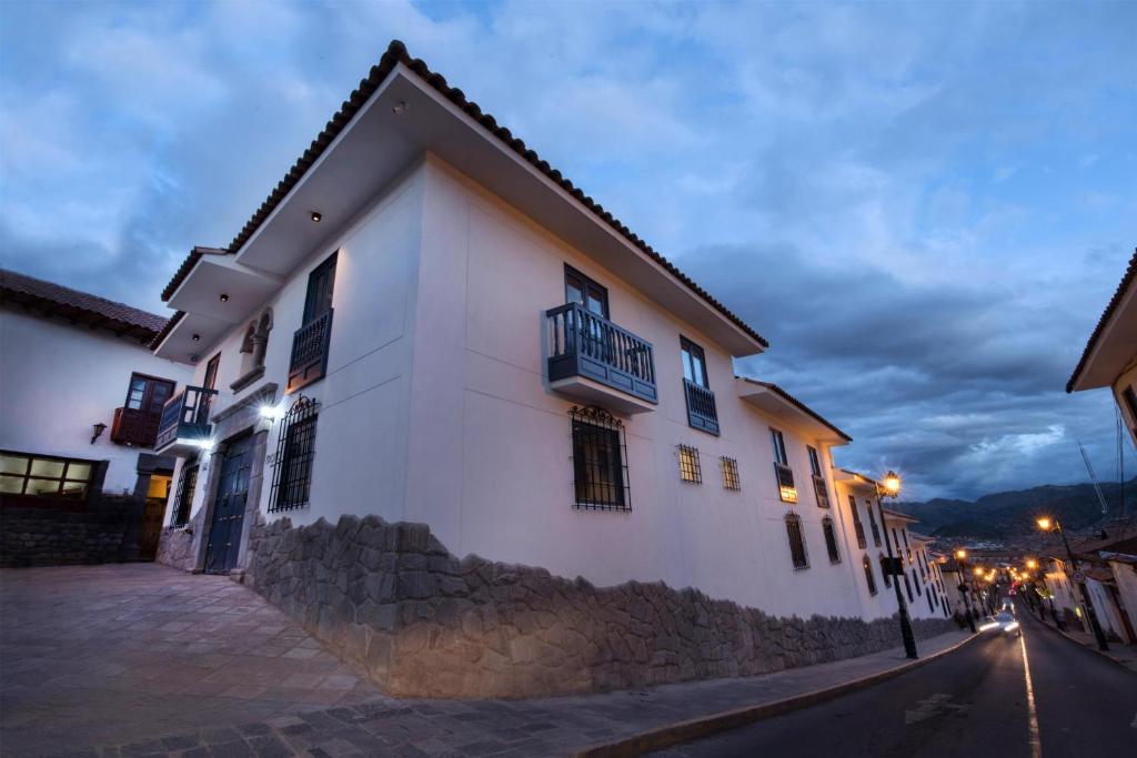 a white building on the side of a street at night at Motto By Hilton Cusco in Cusco