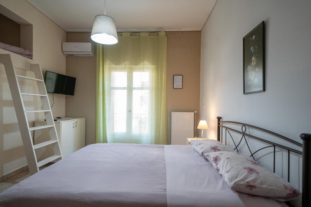 a bedroom with a bed and a window at Delphian Colors - Red Edition by Filos Inc in Delphi
