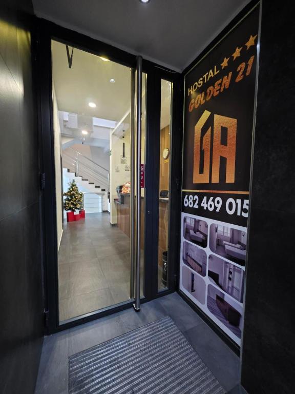 a entrance to a building with a sign on the door at HOSTAL GOLDEN 21*** in Madrid