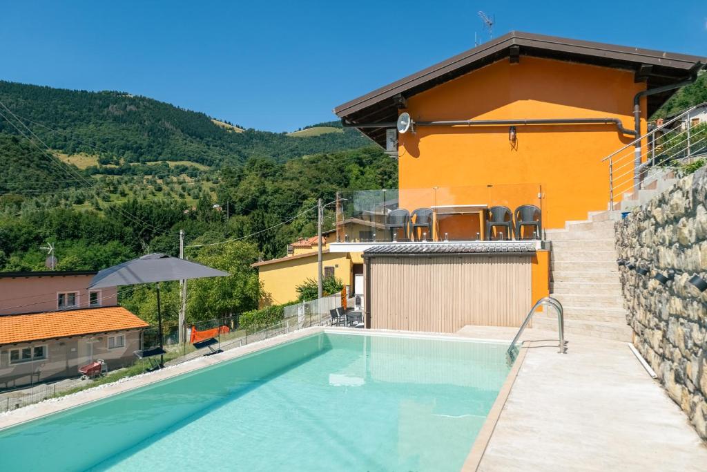 a swimming pool in front of a house at Casa Santari in Parzanica