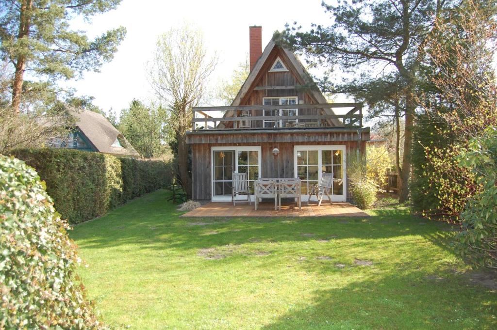 a small house with a porch in a yard at Sonnendeck in Born