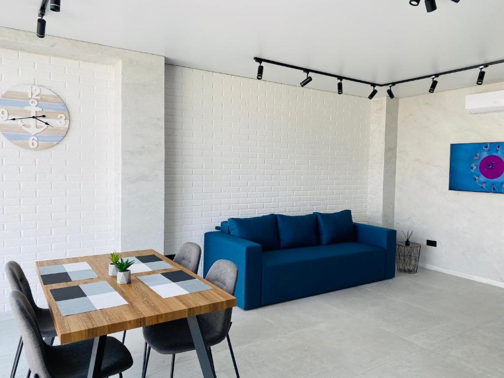 a living room with a blue couch and a table at Золотий Бугаз корп5 апарт3 in Odesa