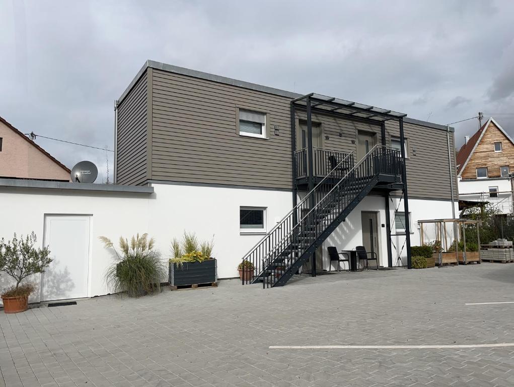 a house with a staircase on the side of it at Schäfer Apartments in Oberderdingen