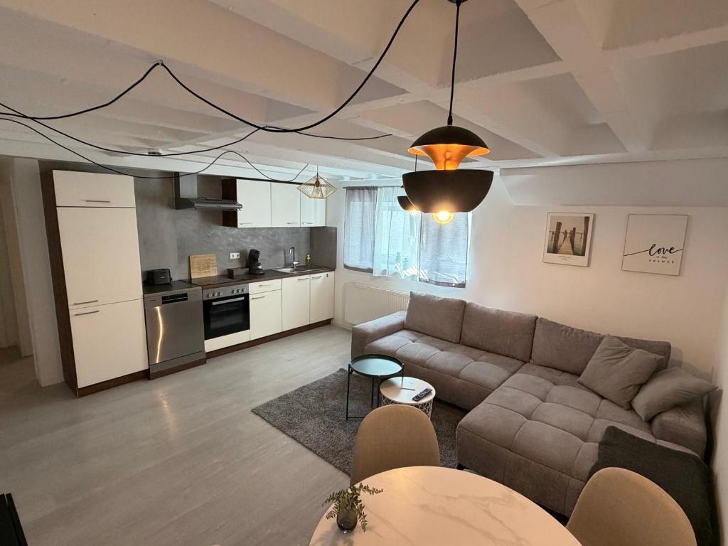 a living room with a couch and a kitchen at 2-Zimmer Souterrain Wohnung in Kehl am Rhein
