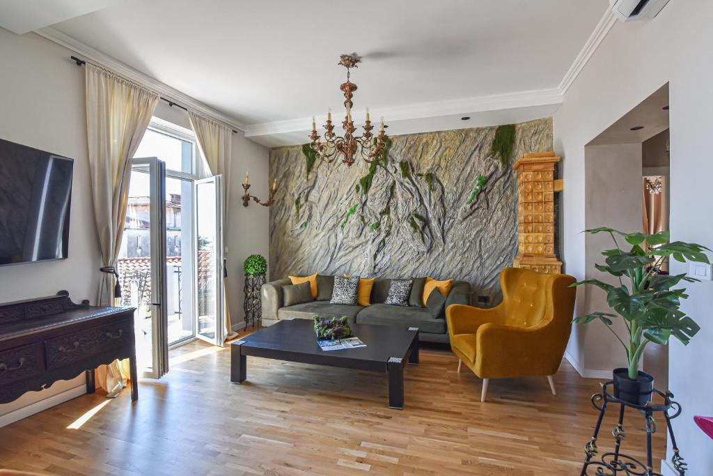 a living room with a couch and a piano at Lovran deluxe apartman in Lovran