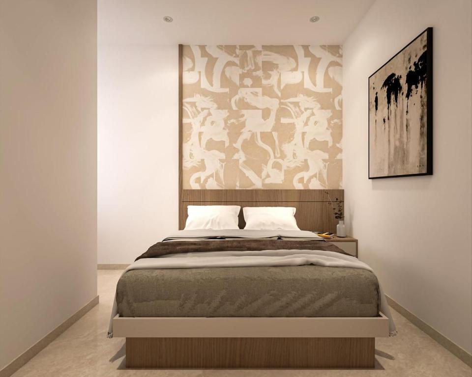 a bedroom with a large bed with a wall at Backwoods inn in Heggadadevankote