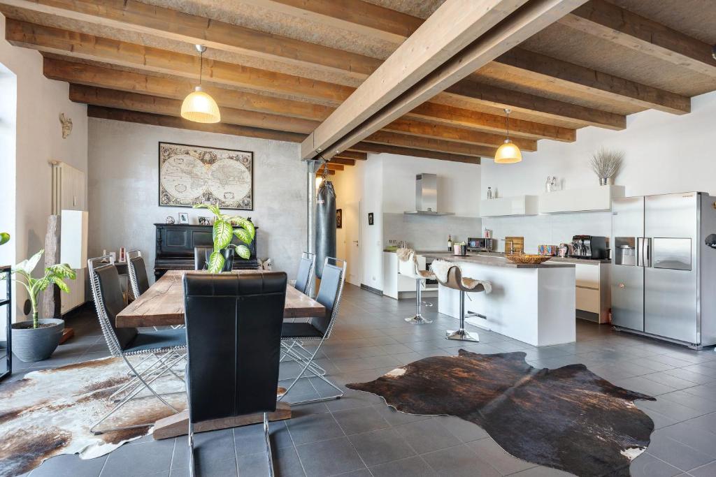 a kitchen and dining room with a table and chairs at Deluxe Loft Hegau Bodensee in Hilzingen