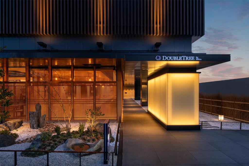 a building with a lit up door in front of it at DoubleTree by Hilton Kyoto Station in Kyoto