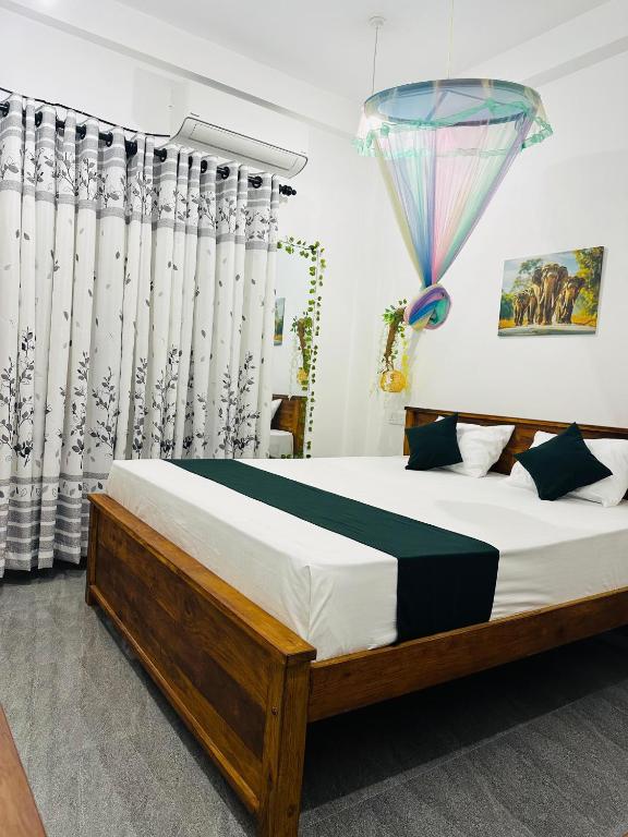a bedroom with a bed with a umbrella on top of it at Tuskers edge Retreat in Udawalawe