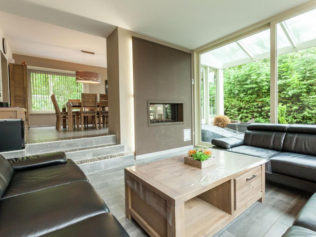 a living room with a couch and a coffee table at Luxury Villa with Sauna and bubble bath in Middelkerke