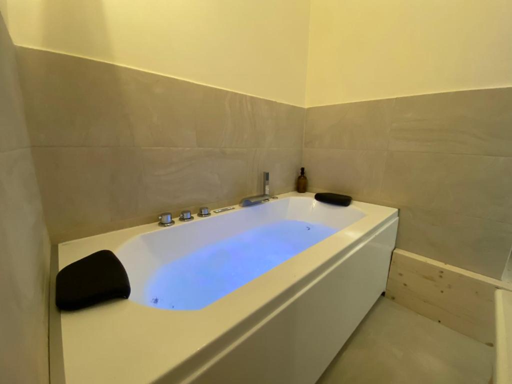 a white bath tub in a bathroom with at Le Cocon du Büech in Veynes