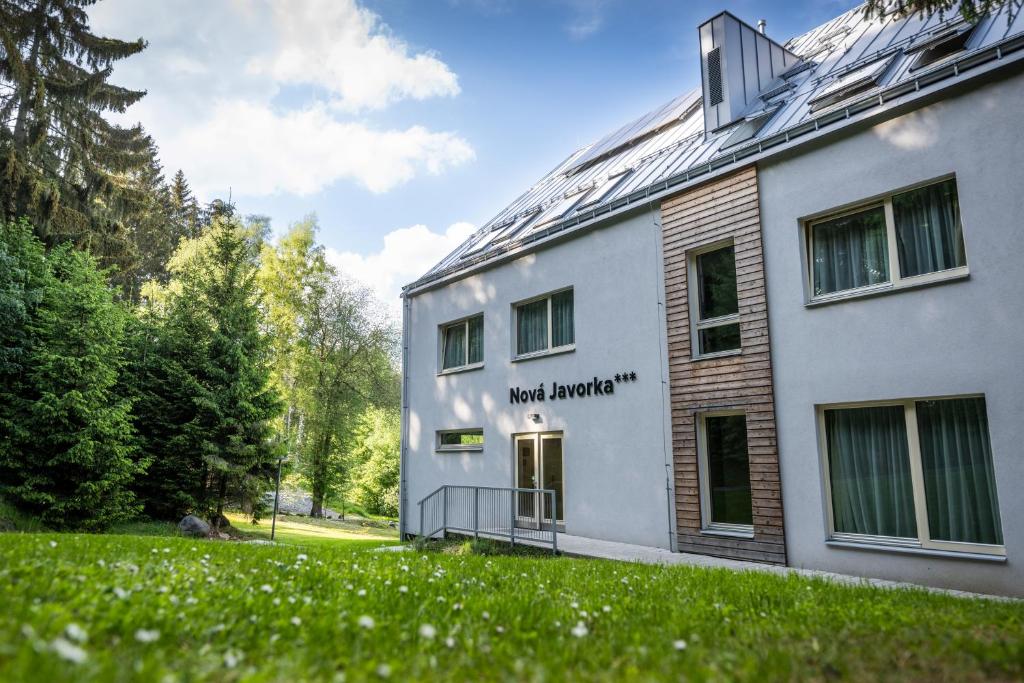 a white building with the words north american at Hotel Monínec - Depandance Nová Javorka in Moninec