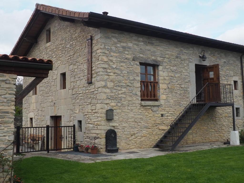 a stone building with a staircase on the side of it at Arteondo in Mendeica