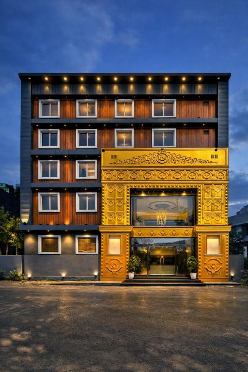 a large yellow building with a large window at Minta Hotel and Banquet in Noida