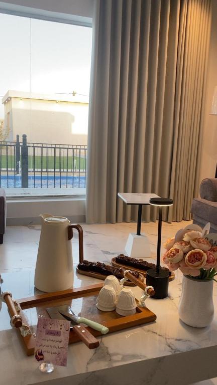 a table with a mortar and pestle on top of a room at شاليه السمو الفندقي in Umm Lajj