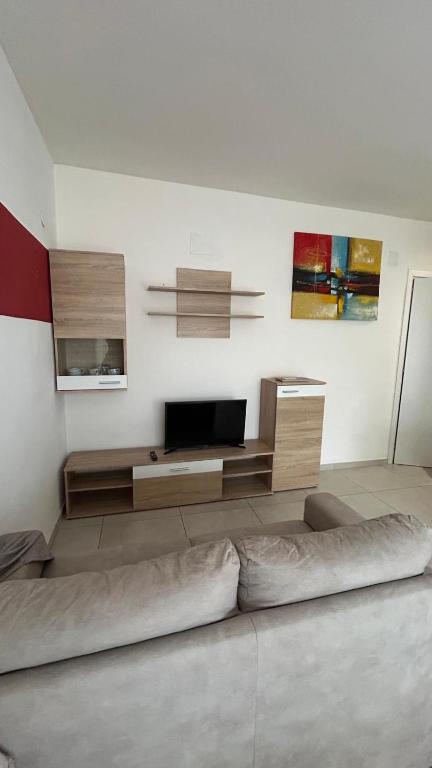 a living room with a flat screen tv on a wall at Luminoso Appartamento al mare in Martinsicuro
